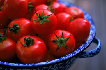 A close up view of cherry Tomatoes in a colander.