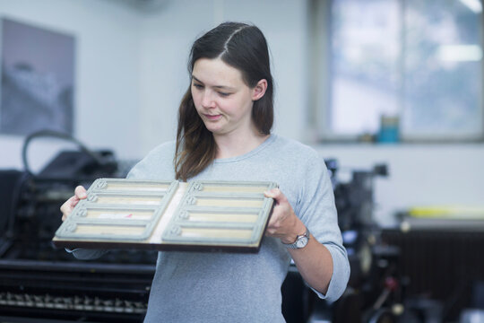 Print worker examining printing plate in an industry, Freiburg im Breisgau, Baden-W&uuml;rttemberg, Germany