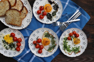 Healthy breakfast . Freshly made, delicious meal of eggs and vegetables. Fried eggs with herbs, leek, onion, kale, dill