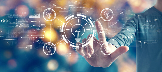 Idea light bulb theme with man on blurred city light background