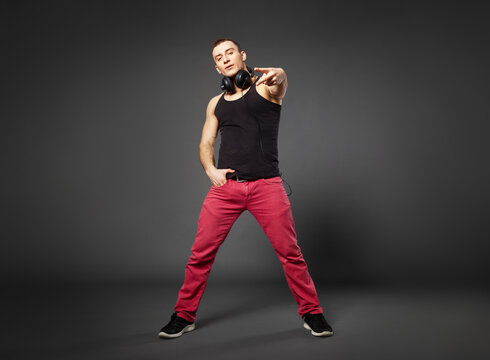 Full body portrait of young confident man on gray background.