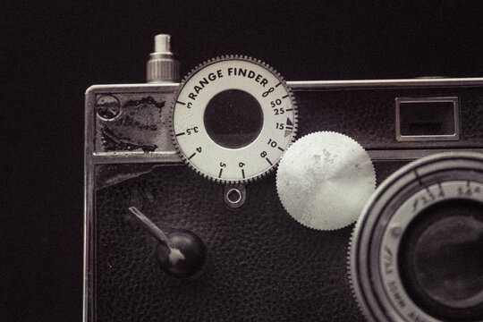 A close-up of a range finder camera (Argus Brick) - with the shutter button and Range Finder dial 