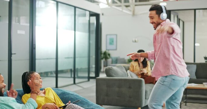 Man dancing, happy business people and office at team building, motivation and crazy time at tech startup. Young programming group, funny dancer and headphones for happiness with corporate culture