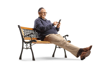 Mature man sitting on a bench and using a smartphone