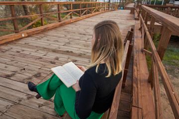 Woman reading on a wooden bench