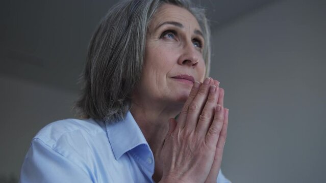Senior woman praying God, asking to heal and bless her unhealthy husband