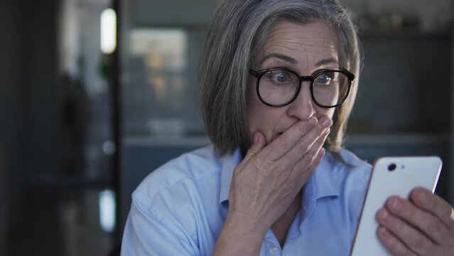 Ault lady reading shocking news in internet, receiving letters with spam content