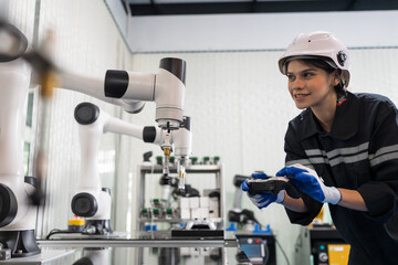 Female engineer control autonomous mobile robot or AMR in the laboratory room. Woman engineer training or maintenance AI robot