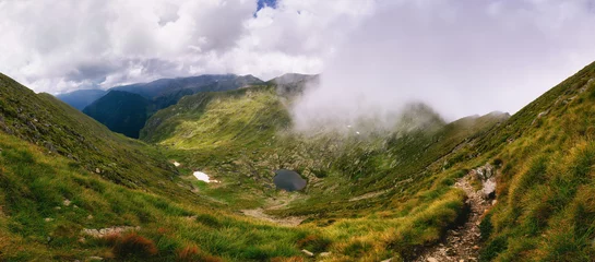Fotobehang Purper Amazing panoramic landscape mountains and hills . View of stone cliffs and valley covered wild grass. Nature landscape at the summertime. Fagaras Mountains. Carpathians. Transylvania. Romania.  © vovik_mar