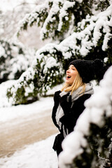 Young woman n warm clothes enjoying in snow