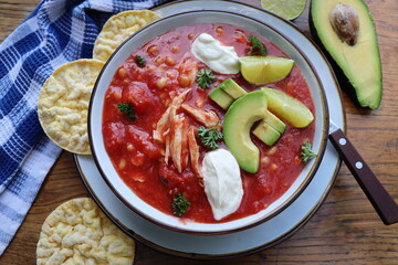 Chicken tortilla chili soup with beans, avocado, lime, . Mexican traditional dish