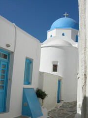 Fototapeta na wymiar Blue domed white church in Lefkes, Paros, Greece