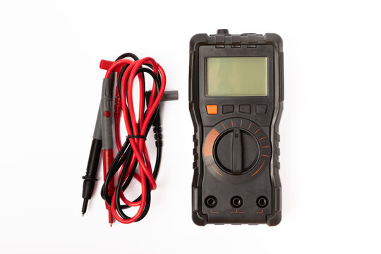 Black digital multimeter with probes isolated on white background. Multimeter is an electronic measuring instrument. Business and profession electrician. Electric concept tool.