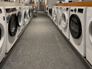 Washing machine shop. Household appliances store. Washing and drying machines.