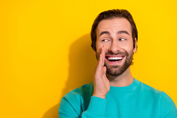 Fototapeta premium Photo of funky dreamy man wear turquoise clothes arm mouth looking empty space isolated yellow color background