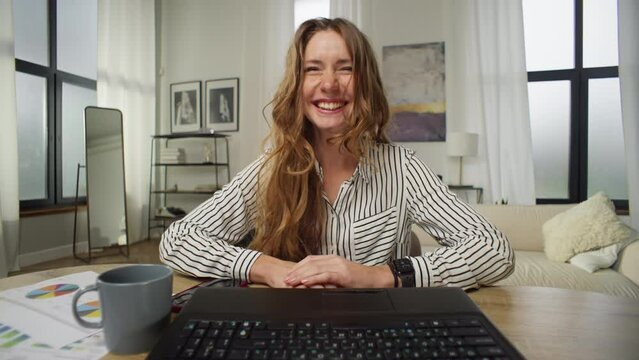 Caucasian Woman Laughing And Happy While Chatting On Video Call In Home Office. A Businessman Laughs At The Computer. Online Remote Work And Zoom Meetings. High Quality 4k Footage