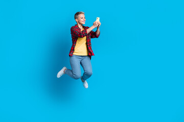 Fototapeta na wymiar Full length size cadre of positive freelancer blogger girl student hold apple iphone video recording selfie cadre isolated on blue color background