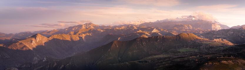 Fototapeta premium Panoramic mountain of Asturias with blue sky with few clouds. Mountains with fog