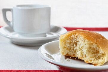 Bitten cake and cup of coffee