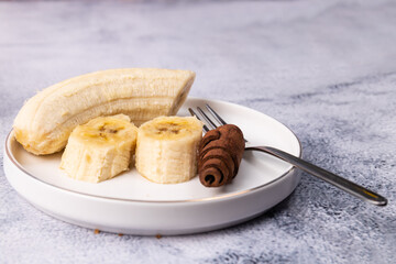 banana slices and cinnamon sticks on chalkboard with copy space