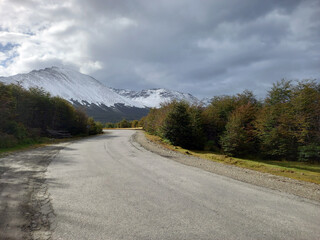 Curved asphalt road in Andes snowy mountain range landscape. Landscape and extreme nature.