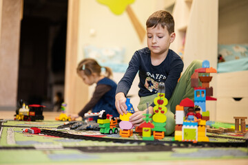 Child leisure activity, creative game. Brother and sister play at home.