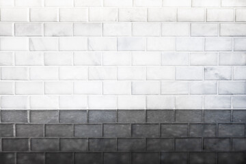 White subway tile background pattern with reflection on black granite stone counter in modern clean sterile kitchen