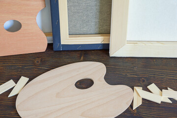Stretched canvases and wooden palettes on  rustic table