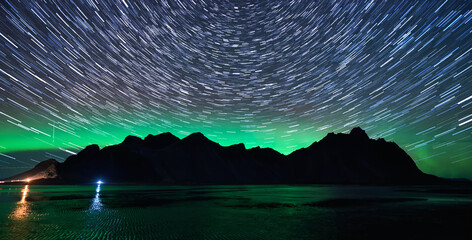 Iceland Mountain iver Northern lights and star trails