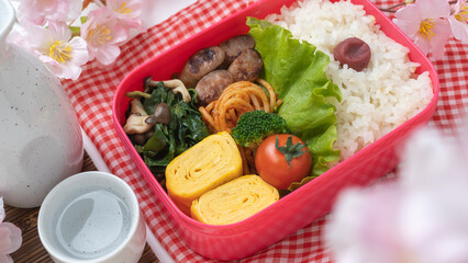 桜とお弁当と日本酒・お花見イメージ
