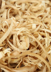 Wood shavings, background. Coarsely grated sawdust. Yellow lumber