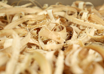 Wood shavings, background. Coarsely grated sawdust. Yellow lumber