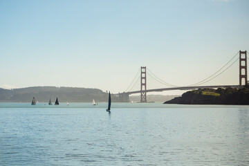 Unusual View of the Golden Gate Bridge and Sailboats. 