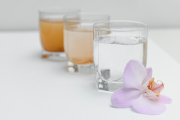 Filter system for water treatment with glasses of clean and dirty water on bright background