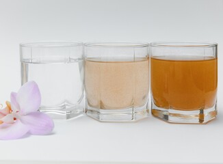 Water filters. Concept of three glasses on a white background. Household filtration system.