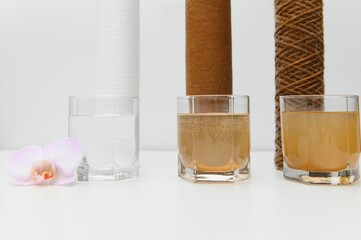 Water filters. Concept of three glasses on a white background. Household filtration system.