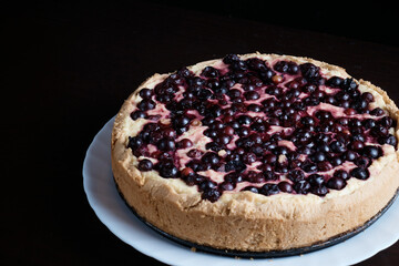 freshly baked berry pie on dark background, close-up, dessert with fresh fruit, hot, steaming
