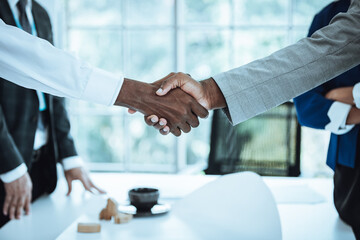 close up businesspeople hands shaking hands with partners after successful a job in the office(vintage tone)