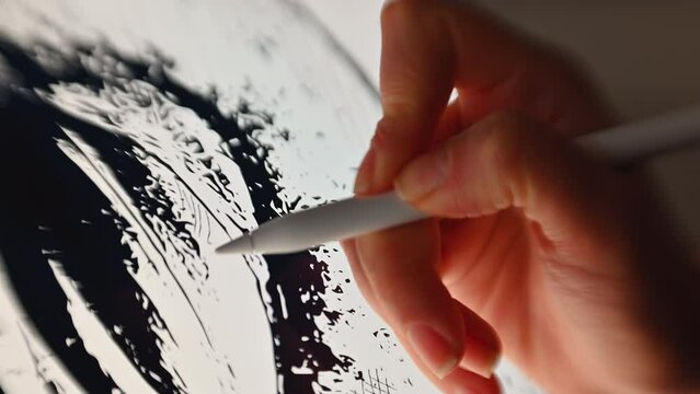 Woman hand painting on a graphic tablet with a white pen, close up