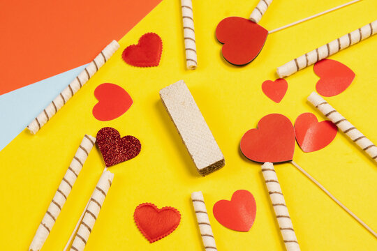 Valentine's Day. Frame of gifts, candles, confetti on a colorful background. Valentine's day background.