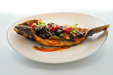 Dish of baked bream with vegetables in a gourmet restaurant
