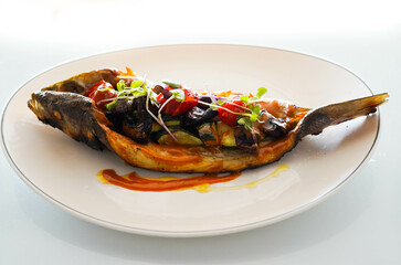 Dish of baked bream with vegetables in a gourmet restaurant
