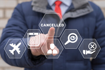 Businessman using virtual touchscreen presses word: CANCELLED. Concept of cancelled. Cancellation....