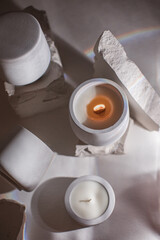 Candle soy homemade in ceramic burning on grey background, atmosphere and minimalistic composition