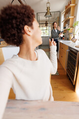 Happy diverse lesbian couple having video call
