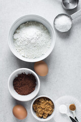 Flatlay of ingredients for making chocolate cake, ingredients for making chocolate madeleines