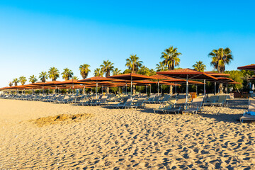 Sunbeds and umbrellas on the sandy beach in Luxury tourist resort