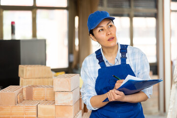 Portrait of an asian builder woman who checks the completed work on