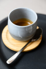 Espresso in a handmade cup with a spoon