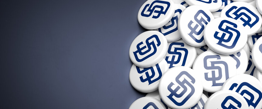 Logos of the American Major League Baseball Team San Diego Padres on a heap on a table.